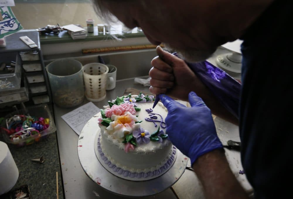 In this March 10, 2014 photo, Masterpiece Cakeshop owner Jack Phillips decorates a cake inside his store, in Lakewood, Colo. (Brennan Linsley/AP)