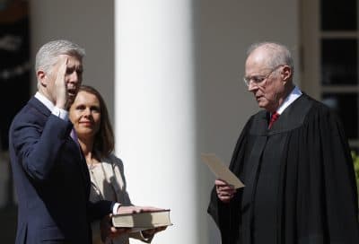 Supreme Court Justice Anthony Kennedy administers the judicial oath to Justice Neil Gorsuch during a re-enactment in the Rose Garden of the White House on April 10, 2017. Holding the bible is Gorsuch's wife Marie Louise Gorsuch. (Carolyn Kaster/AP)