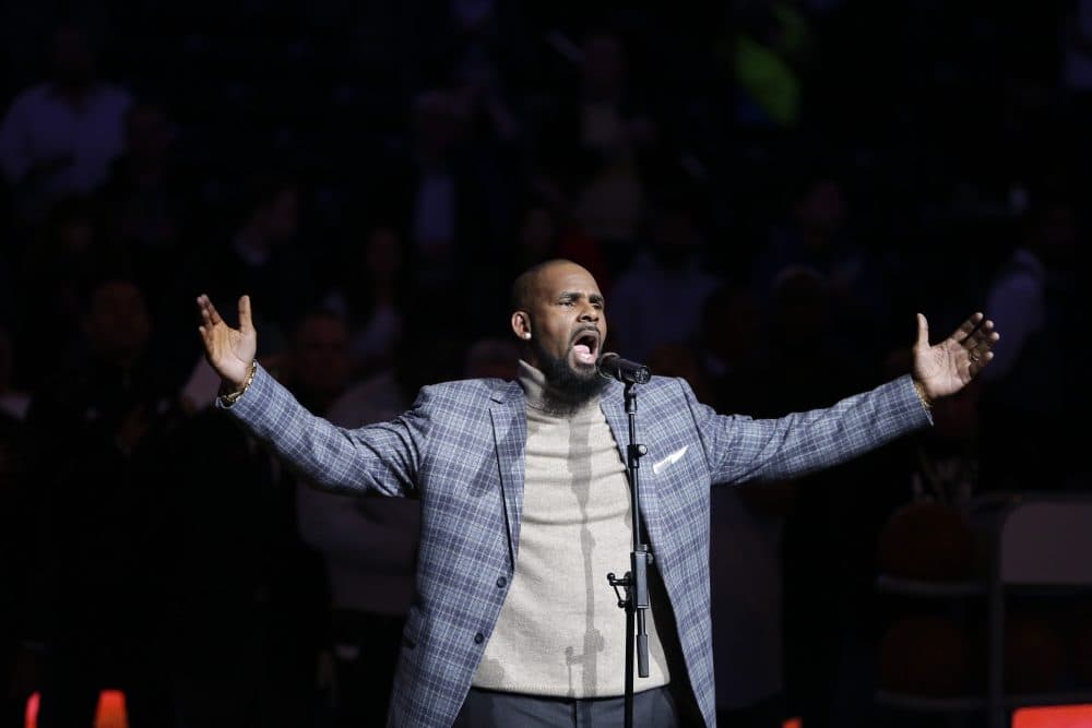 FILE - In this Nov. 17, 2015 file photo. musical artist R. Kelly performs the national anthem before an NBA basketball game between the Brooklyn Nets and the Atlanta Hawks in New York.  Officials in a Georgia county want an upcoming concert by R. Kelly canceled after a media report accusing the singer of mental and physical abuse of women. The Fulton County Board of Commissioners this week sent a letter asking Live Nation, the company contracted to book events at a county-owned venue outside Atlanta, to cancel Kelly’s Aug. 25, 2017 concert.(AP Photo/Frank Franklin II)