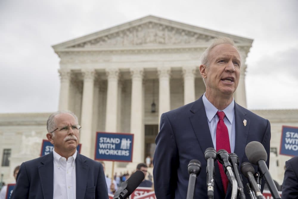 Illinois Gov. Bruce Rauner, right, accompanied by plaintiff Mark Janus, speaks outside the Supreme Court Wednesday, after the court ruled in a setback for organized labor that states can't force government workers to pay union fees. (Andrew Harnik/AP)