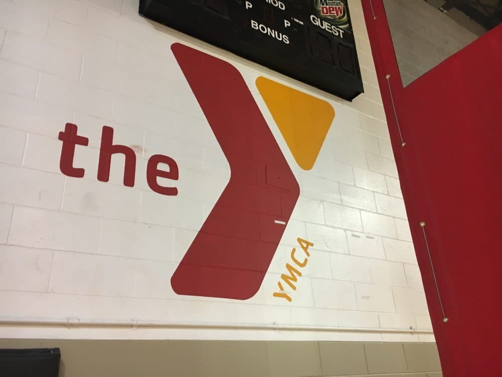 The YMCA logo decorates the wall at the Roxbury YMCA. (Paris Alston/WBUR)