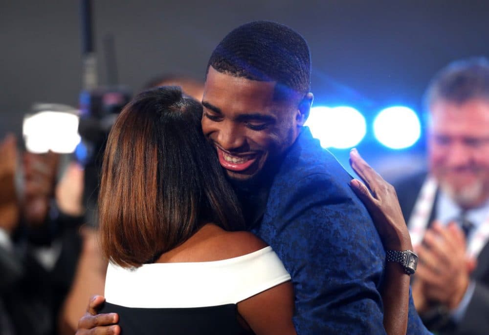 Mikal Bridges hugs his mom, Tyneeha Rivers, after being drafted tenth by the Philadelphia 76ers, for which Rivers works. Bridges was then traded to Phoenix. (Mike Stobe/Getty Images)
