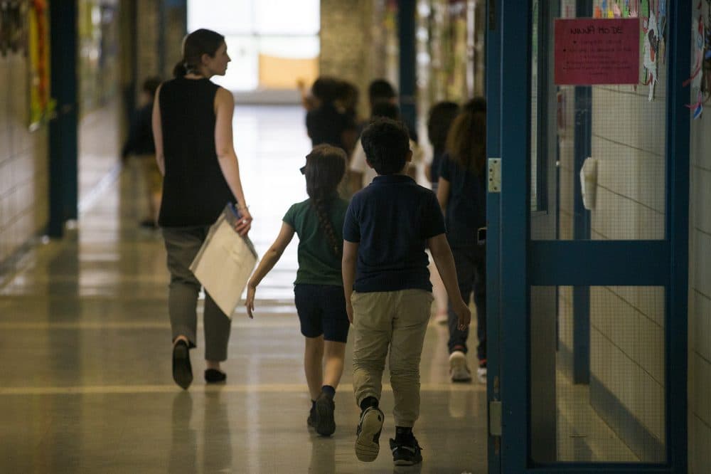 A teacher leads her class through a hallway of Garfield Elementary School in Revere. (Jesse Costa/WBUR)