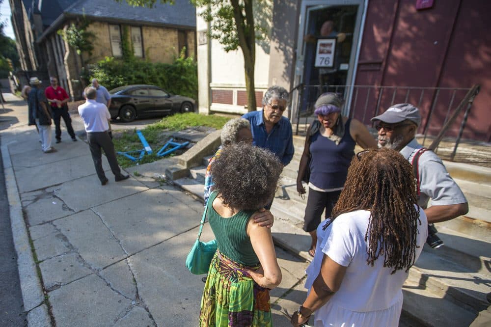 Members of the African-American Master Artists-in-Residence Program (AAMARP) gather at the beginning of July outside the 76 Atherton St. warehouse where the artist collective is located. (Jesse Costa/WBUR)