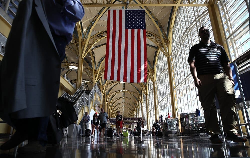 Travelers walk to their gates in the concourse of Reagan National Airport in advance of the Fourth of July holiday on June 29, 2018, in Washington, D.C. TSA has projected that 28.3 million passengers may be expected on the travel dates of June 28 through July 9. (Win McNamee/Getty Images)
