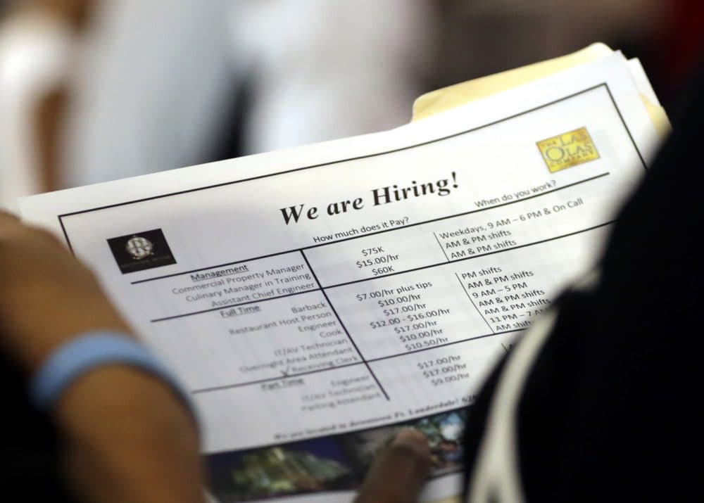 In this Thursday, June 21, 2018 photo, a job applicant looks at job listings for the Riverside Hotel at a job fair hosted by Job News South Florida, in Sunrise, Fla. The Labor Department said Friday, July 6, that the unemployment rate rose to 4.0 percent from 3.8 percent as more people began looking for work and not all of them found it. (Lynne Sladky/AP)
