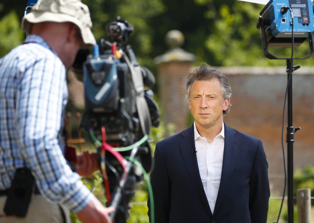 Tom Newton Dunn, political editor of the Sun Newspaper, right, waits to speak to Fox Television News network at Chequers, in Buckinghamshire, England, Friday, July 13, 2018. In an interview with Sun newspaper, President Trump slammed British Prime Minister Theresa May's plan for British departure from the Europe Union and praised her political rival Boris Johnson, who quit May's Cabinet this week over Brexit differences. (Pablo Martinez Monsivais/AP)
