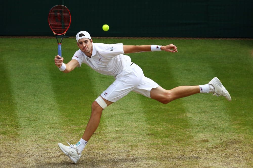 John Isner of the United States returns against Kevin Anderson of South Africa during their men's singles semifinal match on day 11 of the Wimbledon Lawn Tennis Championships at All England Lawn Tennis and Croquet Club on July 13, 2018 in London. (Clive Brunskill/Getty Images)