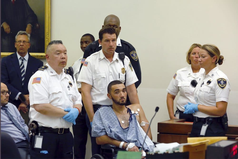 Court officers surround Emanuel Lopes during his arraignment Tuesday in district court in Quincy, Mass. (Greg Derr/The Quincy Patriot Ledger via AP, pool)