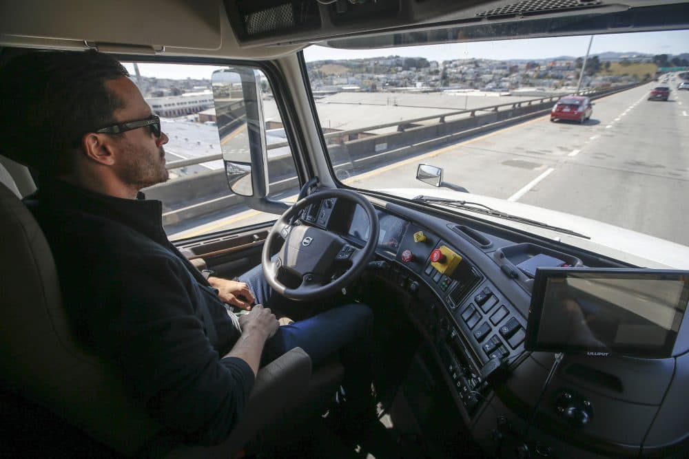 A senior program engineer at Otto, which was acquired by Uber in 2016, takes his hands off the steering wheel of the self-driving, big-rig truck during a highway demonstration. (Tony Avelar/AP)