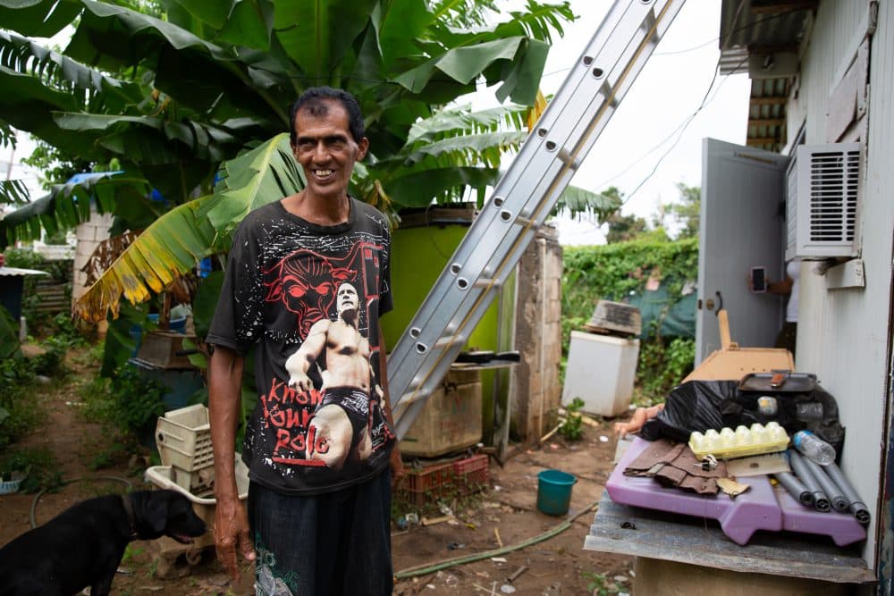Hurricane Maria destroyed Ramón Luis Morales’s roof, but he hasn’t been able to finish rebuilding because he’s still waiting on supplies. In the meantime, he’s helping another man in need fix his house. (Ryan Caron King for Connecticut Public Radio)