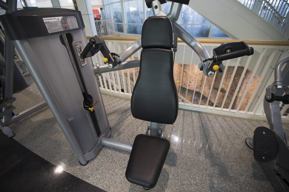 Many gyms are getting rid of certain machines, like shoulder press machines. WBUR's Carey Goldberg isn't happy about that. (Jesse Costa/WBUR)
