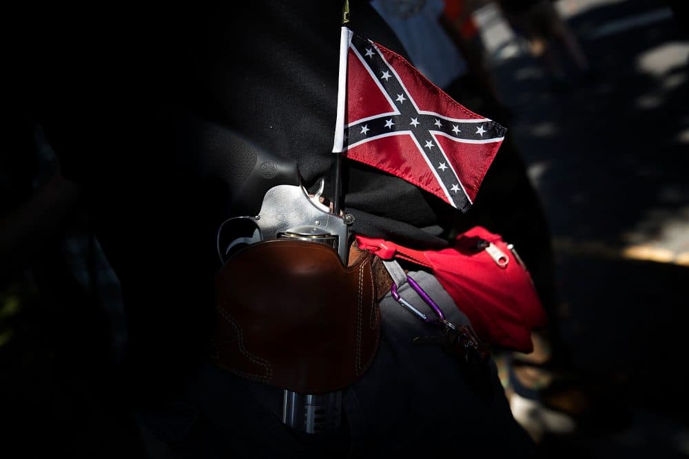 A man carrying a sidearm and Confederate flag attends a protest held by the Tennessee-based group New Confederate State of America on Sept. 16, 2017 in Richmond, Va. (Win McNamee/Getty Images)