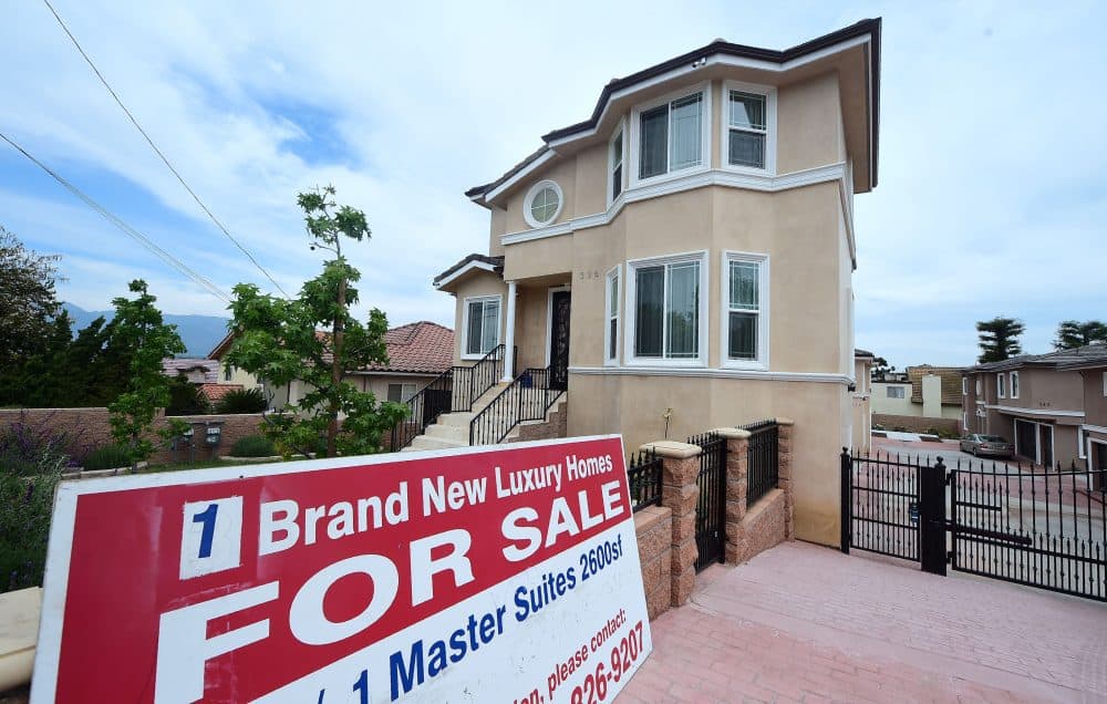 A for-sale sign stands in front of a property in Monterey Park, Calif., in 2017. (Frederic J. Brown/AFP/Getty Images)