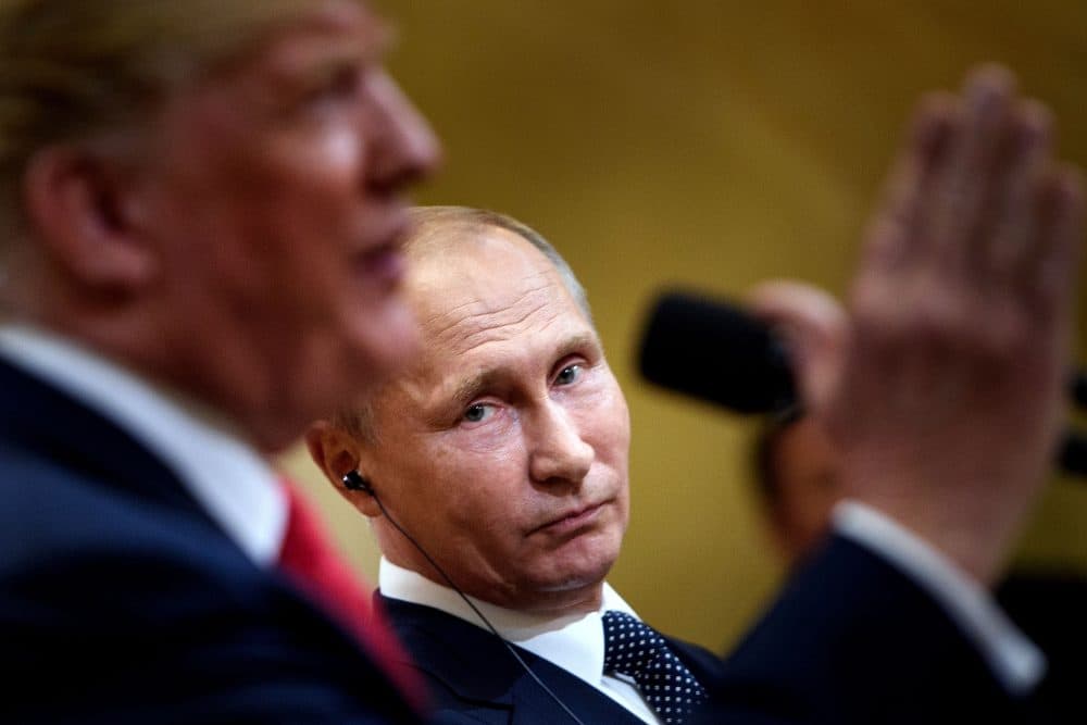 Russian President Vladimir Putin listens while President Trump speaks during a press conference at Finland's Presidential Palace on July 16, 2018 in Helsinki, Finland. (Brendan Smialowski/AFP/Getty Images)