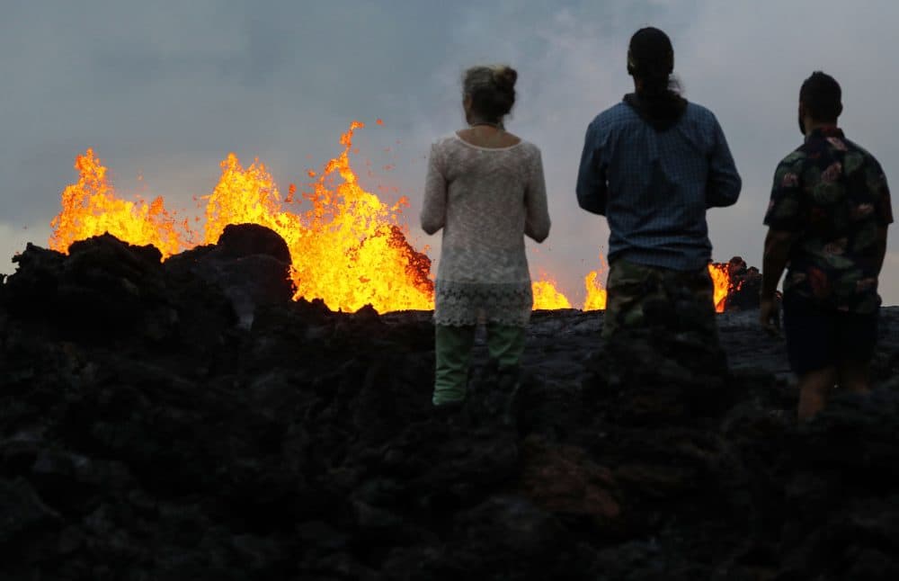 Onlookers watch as lava from a Kilauea volcano fissure erupts in Leilani Estates, on Hawaii's Big Island, on May 26, 2018 in Pahoa, Hawaii. (Mario Tama/Getty Images)