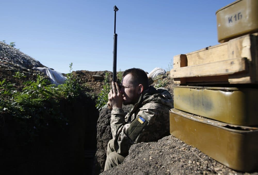 A Ukrainian service member monitors the positions of Russia-backed separatists on the front-line near the southeastern city of Mariupol on June 11, 2018. (Anatolii Stepanov/AFP/Getty Images)