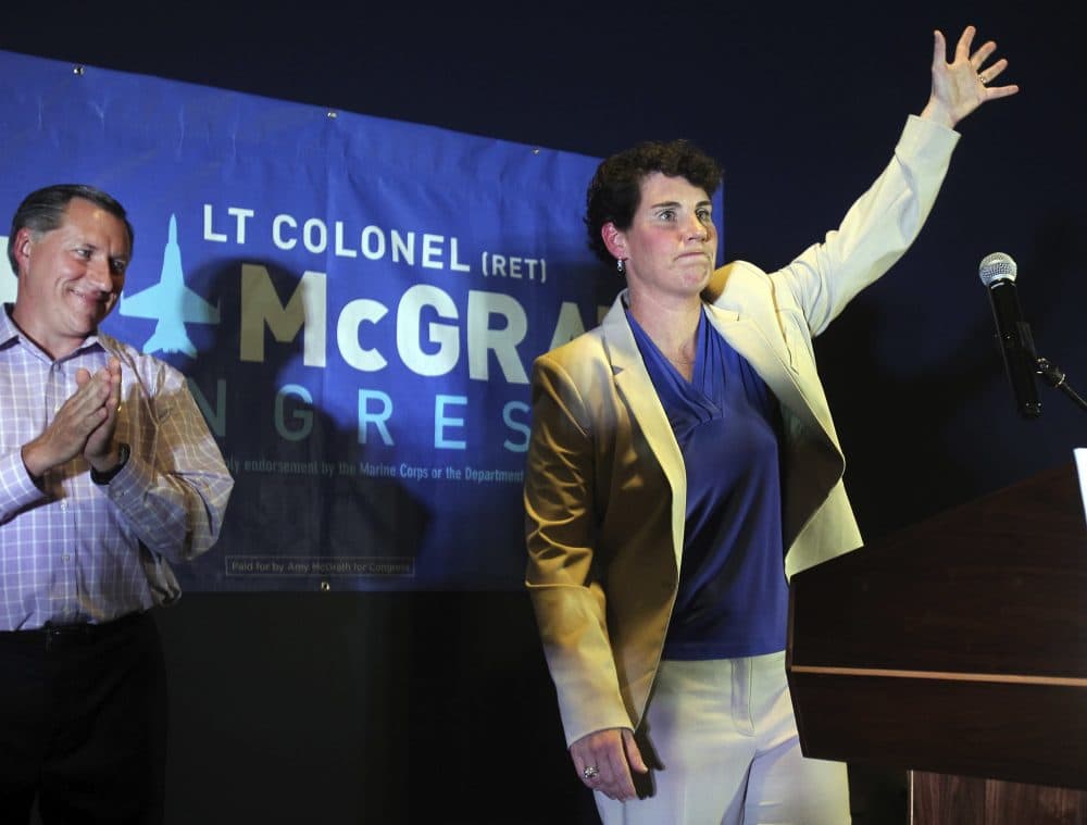 Amy McGrath, right, with her husband, Erik Henderson, waves to supporters after being elected as the Democratic candidate for Kentucky's 6th Congressional District, Tuesday, May 22, 2018, in Richmond, Ky. (James Crisp/AP)