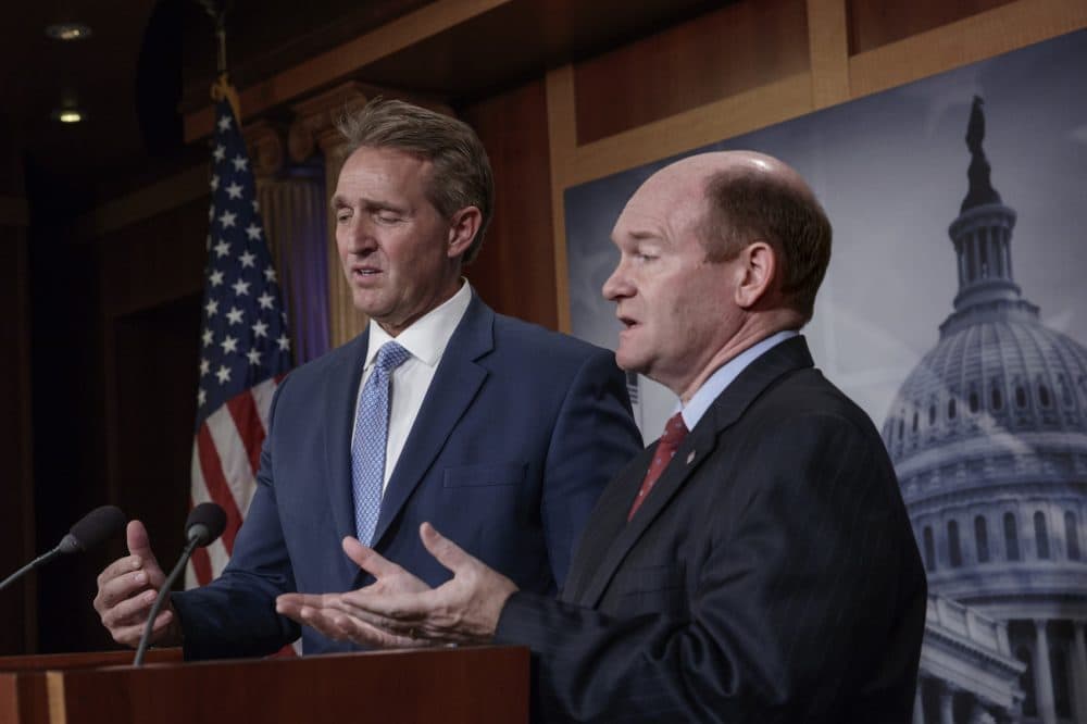 Sen. Jeff Flake, R-Ariz., left, and Sen. Chris Coons, D-Del., talk to reporters after making speeches on the Senate floor calling for a resolution to back the U.S. intelligence community findings that Russia interfered in the 2016 election and calling for other responses to the meddling, on Capitol Hill in Washington, Thursday, July 19, 2018. (J. Scott Applewhite/AP)