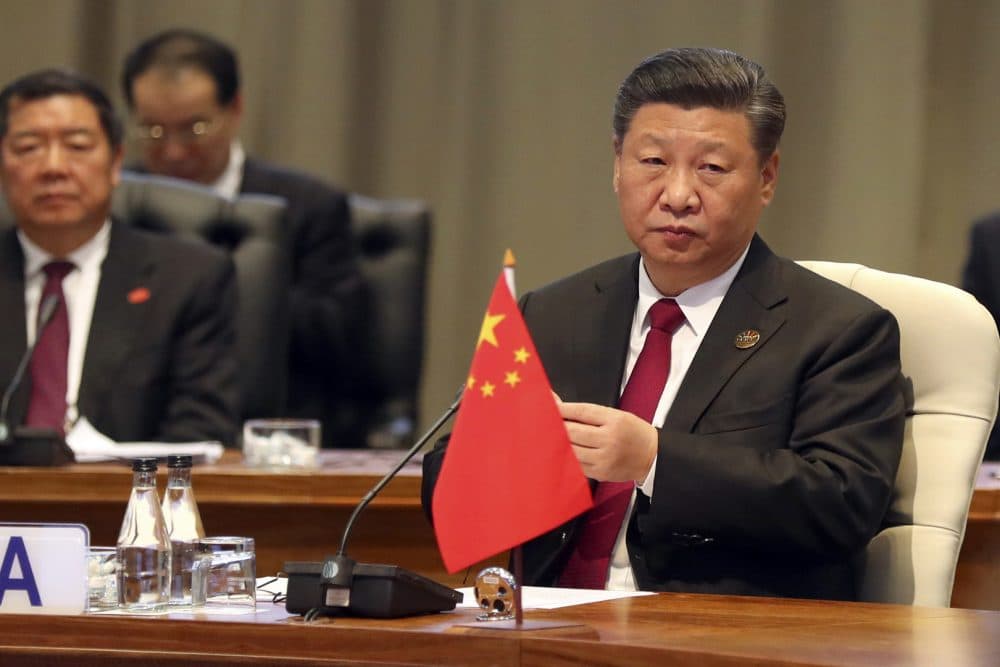 China's President Xi Jinping takes his seat for the first closed session of the BRICS summit, in Johannesburg, South Africa, Thursday, July 26, 2018. The five leaders of the BRICS emerging economies have gathered in South Africa for an annual summit where the United States is being criticized for escalating tariffs on foreign goods. (Mike Hutchings/Pool Photo via AP)
