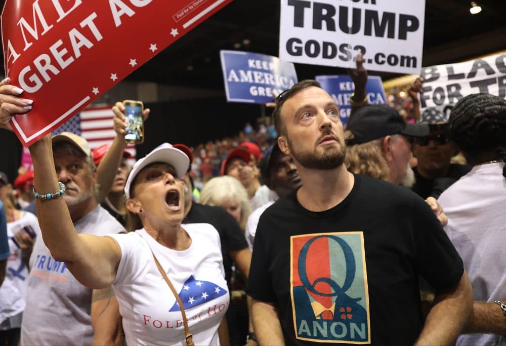 A man wears a shirt with the words &quot;Q Anon&quot; as he attends a rally for President Trump at the Florida State Fair Grounds Expo Hall on July 31, 2018 in Tampa, Fla. (Joe Raedle/Getty Images)