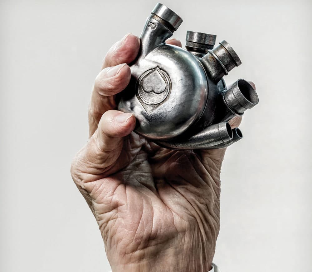 Dr. Bud Frazier’s hand holding his lifelong dream, a self-contained artificial heart, the Bivacor, in 2016. (Texas Heart Institute)
