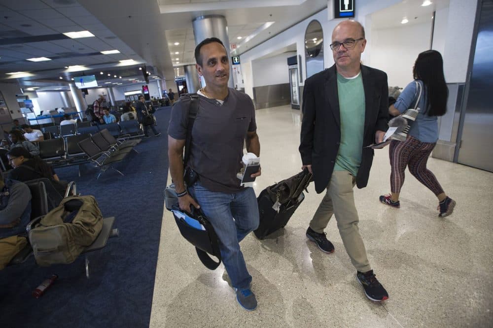 Somerville Mayor Joseph Curtatone, left, and Congressman Jim McGovern walk through Miami International Airport to board their flight to Honduras. (Jesse Costa/WBUR)
