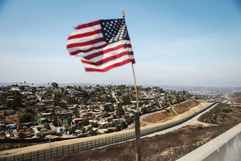 An American flag flies along a section of the U.S.-Mexico border, with the Mexican city of Tijuana in the background, on July 16, 2018 in San Diego, Calif. (Mario Tama/Getty Images)
