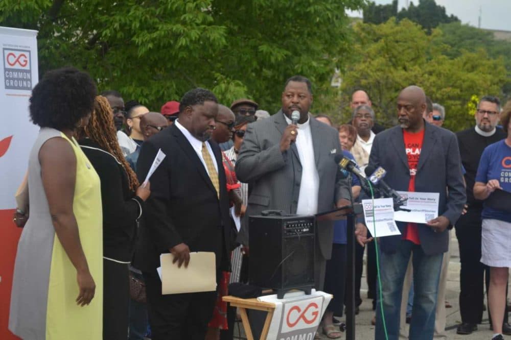 Demetrius Williams of Community Baptist Church in Milwaukee and John K. Patterson (with microphone) of Mt. Olive Baptist Church in Milwaukee speak during an event organized by Common Ground. (Courtesy Common Ground)