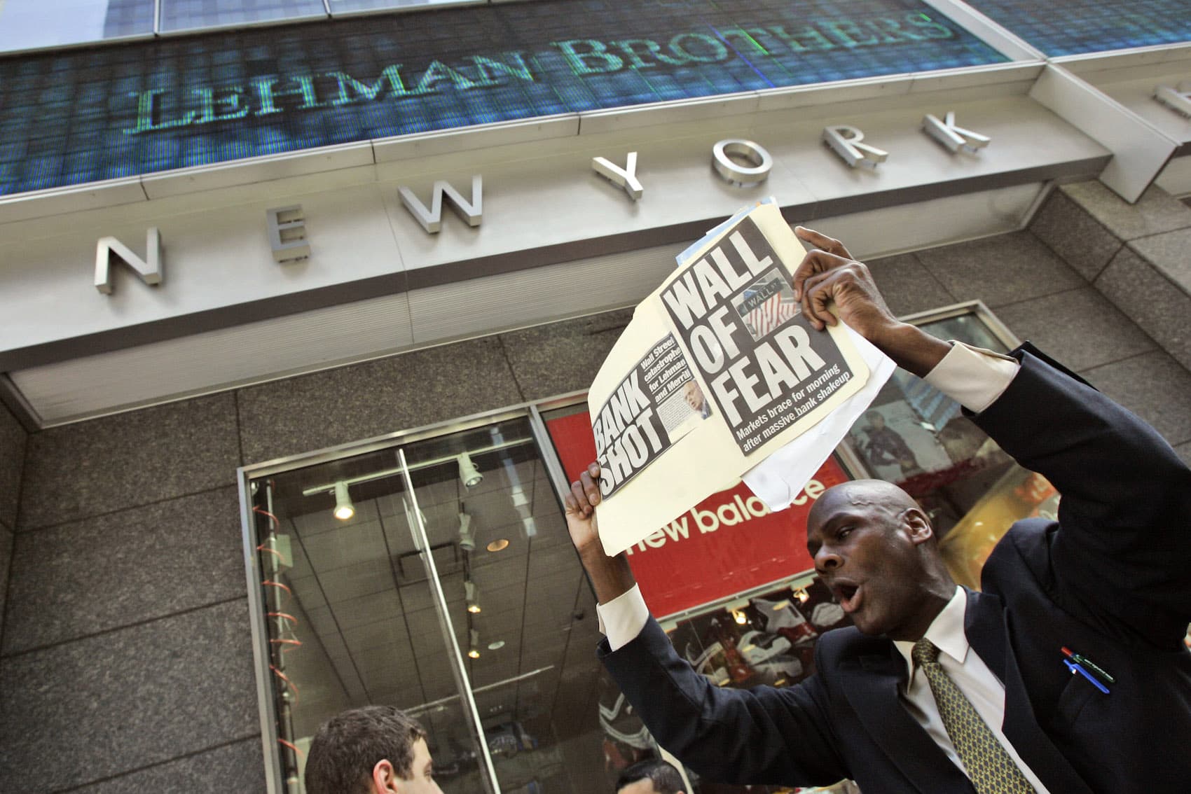 A man demonstrates outside the Lehman Brothers headquarters Monday, Sept. 15, 2008 in New York. When Wall Street woke up Monday morning, two more of its storied firms had fallen. Lehman Brothers, burdened by $60 billion in soured real-estate holdings, filed a Chapter 11 bankruptcy petition in U.S. Bankruptcy Court after attempts to rescue the 158-year-old firm failed. (Mary Altaffer/AP)