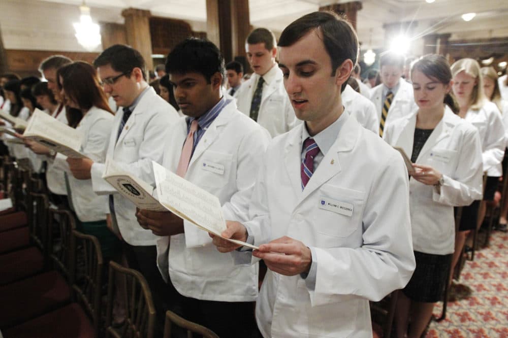 Thomas Jefferson University's Jefferson Medical College first-year student William E. Wieczorek and others take the Hippocratic Oath during the annual White Coat Ceremony, Friday, Aug. 5, 2011, in Philadelphia. The ceremony symbolizes the clinical beginning of the students' medical educations. (Matt Rourke/AP)