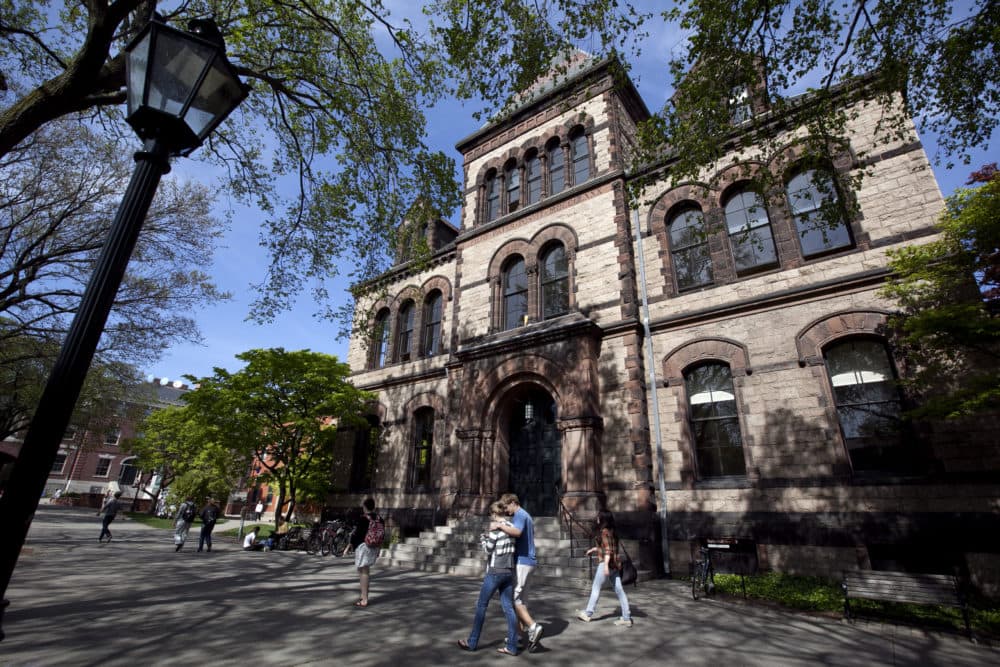 Passers-by walk past Sayles Hall on the campus of Brown University. (Steven Senne/AP)