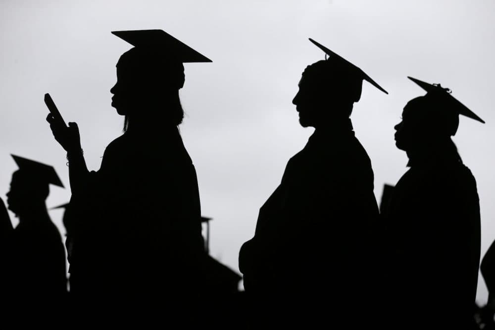 In this May 17, 2018, file photo, new graduates line up before the start of the Bergen Community College commencement at MetLife Stadium in East Rutherford, N.J. Obtaining a college degree has increasingly coincided with ever-higher student debt loads. Since 2004, total student debt has climbed more than 540 percent to $1.4 trillion, according to the New York Federal Reserve. (Seth Wenig, File/AP)