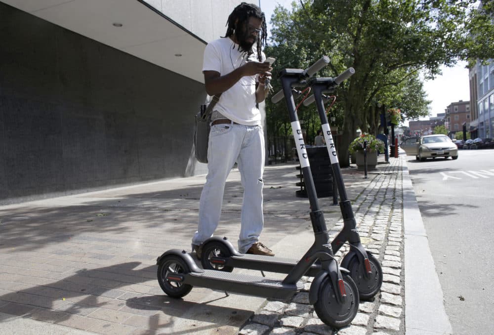 In this Tuesday, July 24, 2018 photo Vatic Kuumba, of Providence, R.I., prepares to ride a Bird electric scooter in downtown Providence. (Steven Senne/AP)