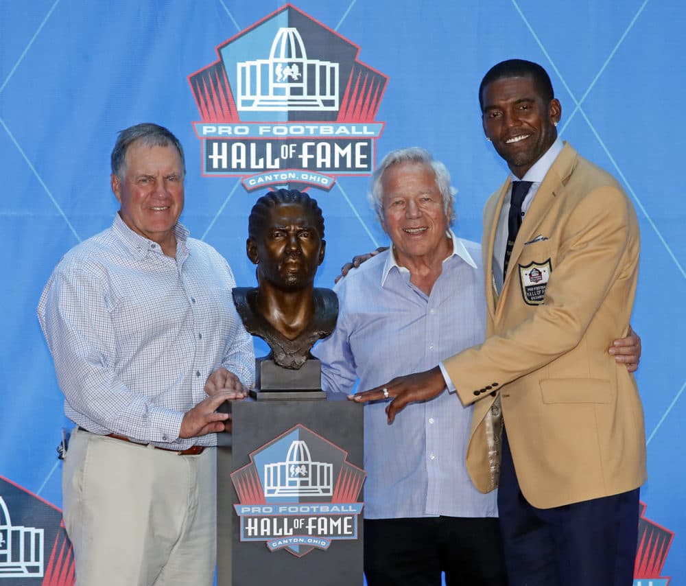 Former NFL wide receiver Randy Moss, right, poses with New England Patriots owner Robert Kraft, center, and coach Bill Belichick and a bust of himself during inductions at the Pro Football Hall of Fame, Saturday, Aug. 4, 2018 in Canton, Ohio. (Gene J. Puskar/AP)