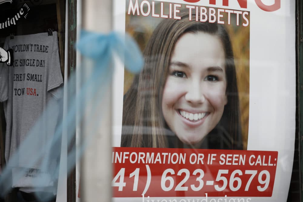 A poster of University of Iowa student Mollie Tibbetts hangs in the window of a local business, Tuesday, Aug. 21, 2018, in Brooklyn, Iowa, the same day authorities found Tibbetts dead. (Charlie Neibergall/AP)