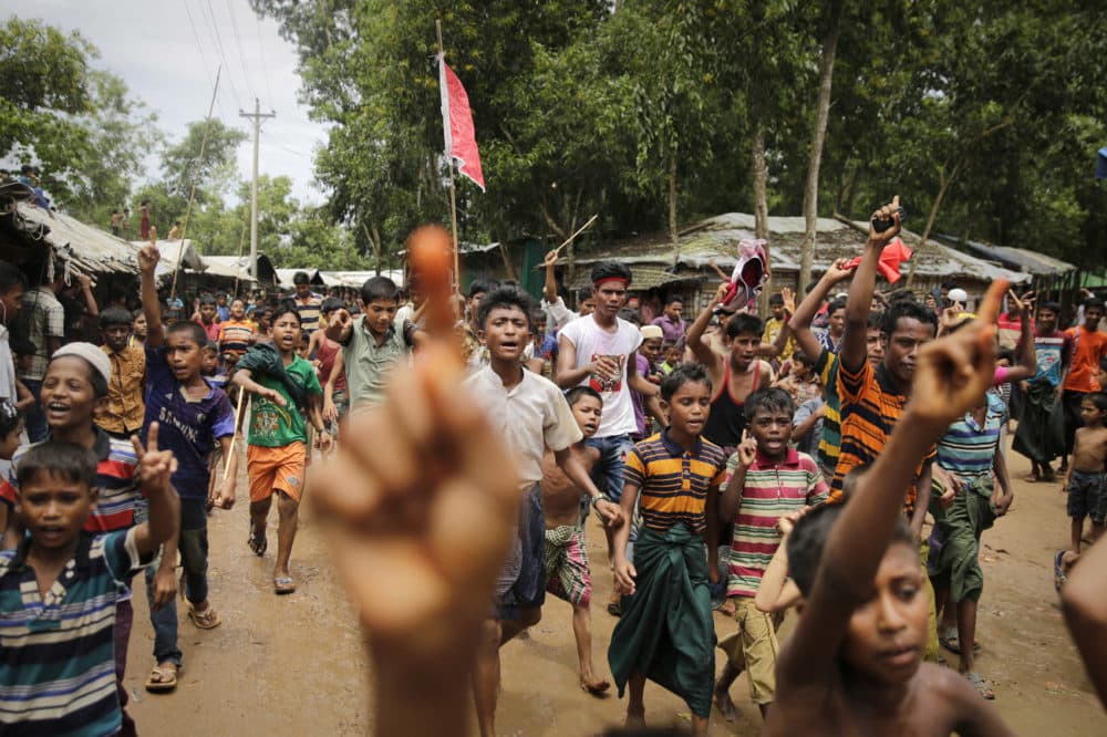 Rohingya refugee boys shout slogans during a protest rally to commemorate the first anniversary of Myanmar army's crackdown which lead to a mass exodus of Rohingya Muslims to Bangladesh, at Kutupalong refugee camp in Bangladesh, Saturday, Aug. 25, 2018. Thousands of Rohingya Muslim refugees on Saturday marked the one-year anniversary of the attacks that sent them fleeing to safety in Bangladesh, praying they can return to their homes in Myanmar and demanding justice for their dead relatives and neighbors. (Altaf Qadri/AP)