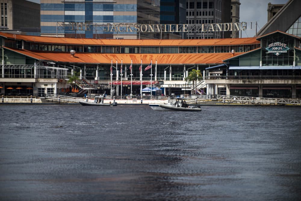 Police patrol the St. Johns River by boat just outside the Jacksonville Landing complex, where there was a shooting Sunday. (Laura Heald/AP)