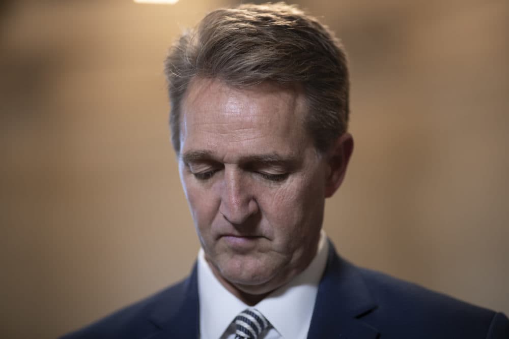 During a television news interview, Sen. Jeff Flake, R-Ariz., shares memories of working with his fellow Arizona senator, John McCain, who died Saturday at age 81 of brain cancer, on Capitol Hill in Washington, Tuesday, Aug. 28, 2018. In today's Arizona primary contests, three Republicans are vying to replace Sen. Flake who is retiring after his fierce criticism of President Donald Trump. (J. Scott Applewhite/AP)