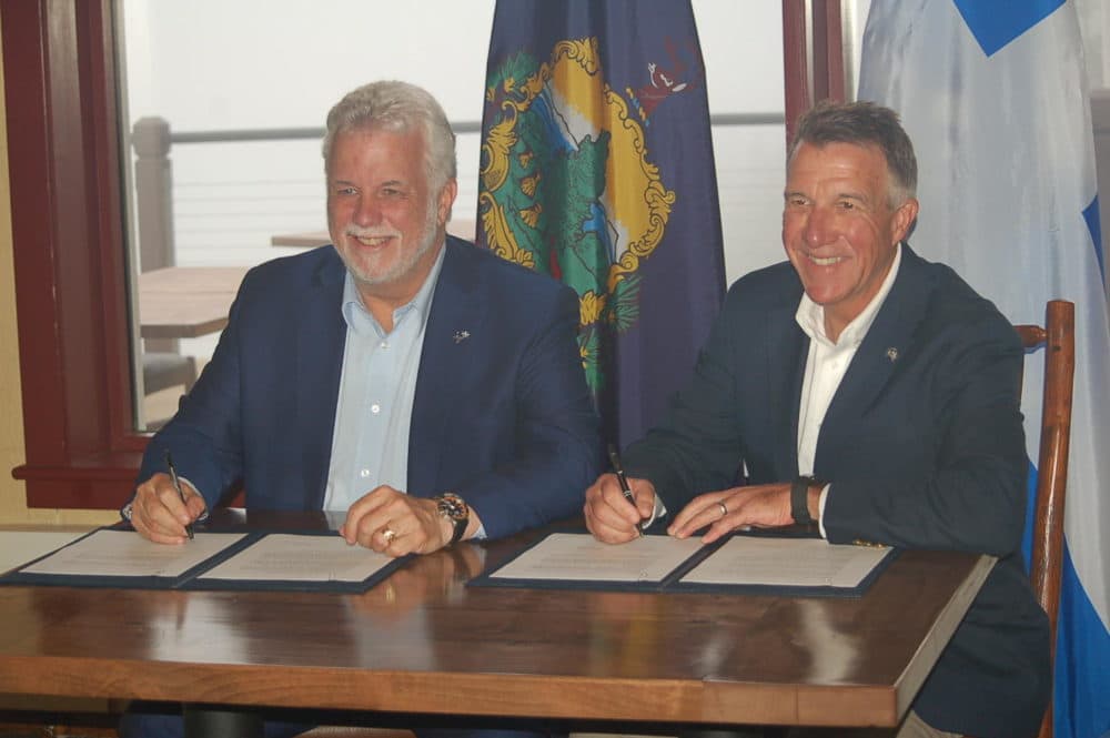 Quebec Premier Philippe Couillard, left, and Vermont Gov. Phil Scott Sunday signed a bilateral agreement pledging continuing cooperation on a host of cross-border issues. (John Dillon/VPR)