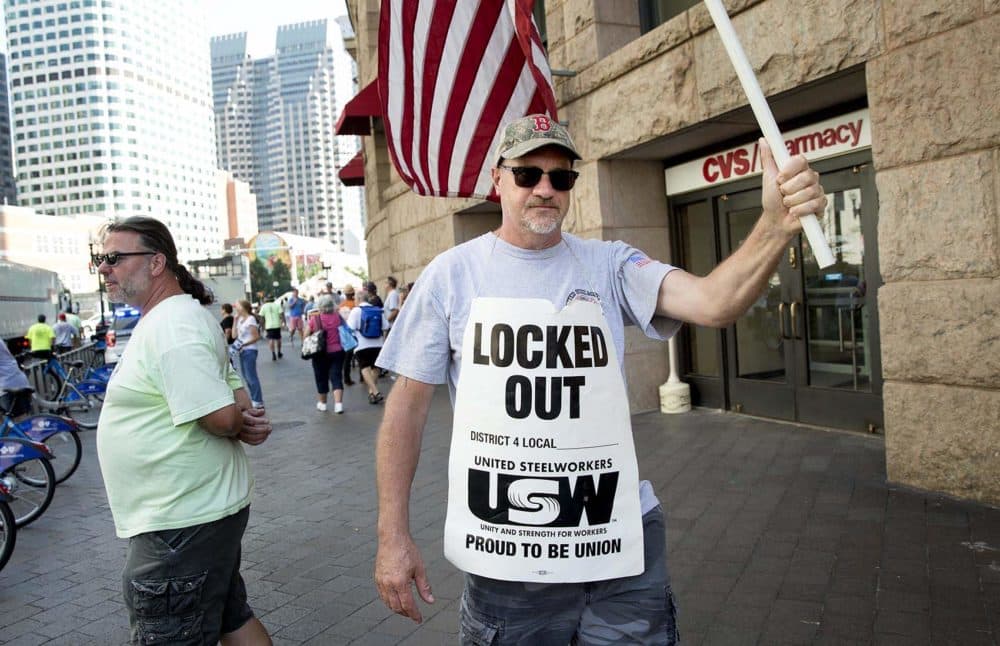 Outside South Station, Charlie Webber, 57, of the United Steelworkers, protests the National Grid lockout. (Robin Lubbock/WBUR)