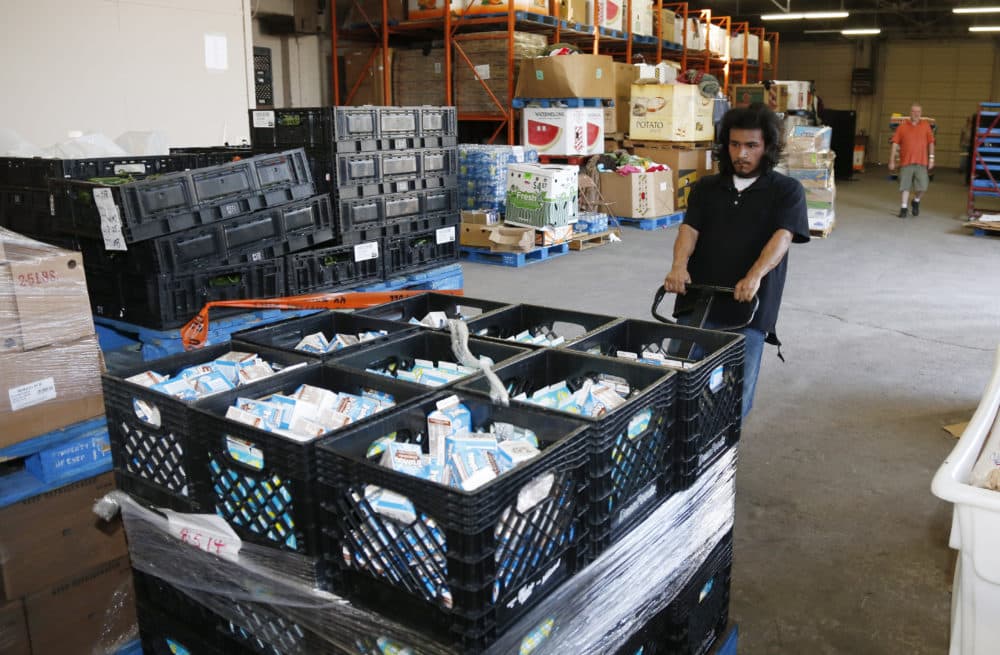 Joseph Elliote moves a pallet full of milk in the Jesus House homeless shelter warehouse in Oklahoma City. (AP Photo)