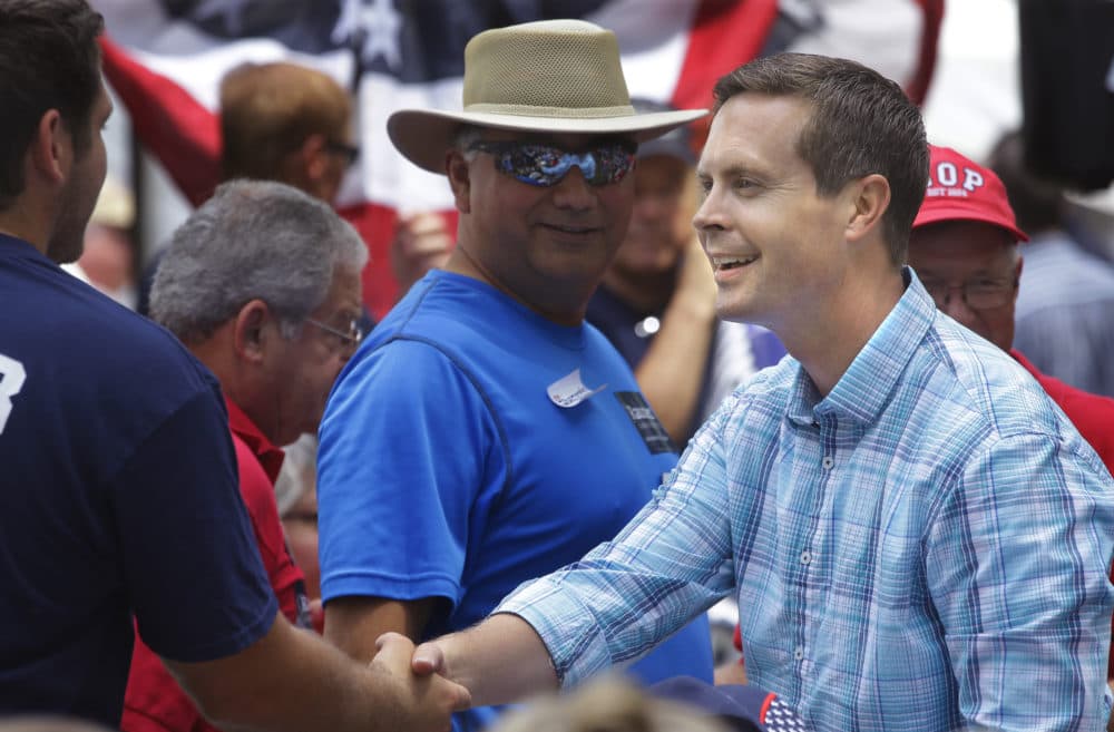 In this Aug. 14, 2014 photo, U.S. Rep. Rodney Davis shakes hands with people attending the Republican Day rally at the Illinois State Fair in Springfield. (Seth Perlman/AP)