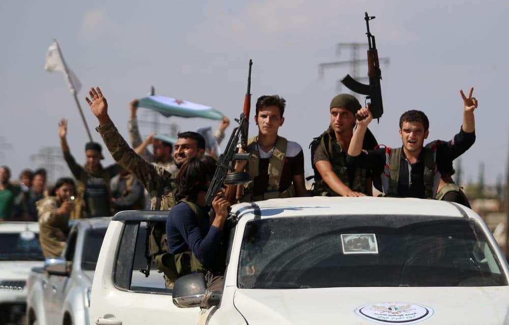 Syrian rebel fighters from the recently formed &quot;National Liberation Front&quot; parade following military training at an unknown location in the northern countryside of the Idlib province on Sept. 11, 2018, in anticipation for an upcoming government forces offensive. (Aaref Watad/AFP/Getty Images)