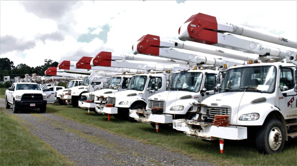 Utility trucks line up in a parking lot adjacent to Charlotte Motor Speedway in Concord, North Carolina, on Wednesday, Sept. 12, 2018. The trucks were staging prior to a trip to Wilmington, North Carolina, to help with power restoration efforts in the wake of Hurricane Florence. (Skip Foreman/AP)