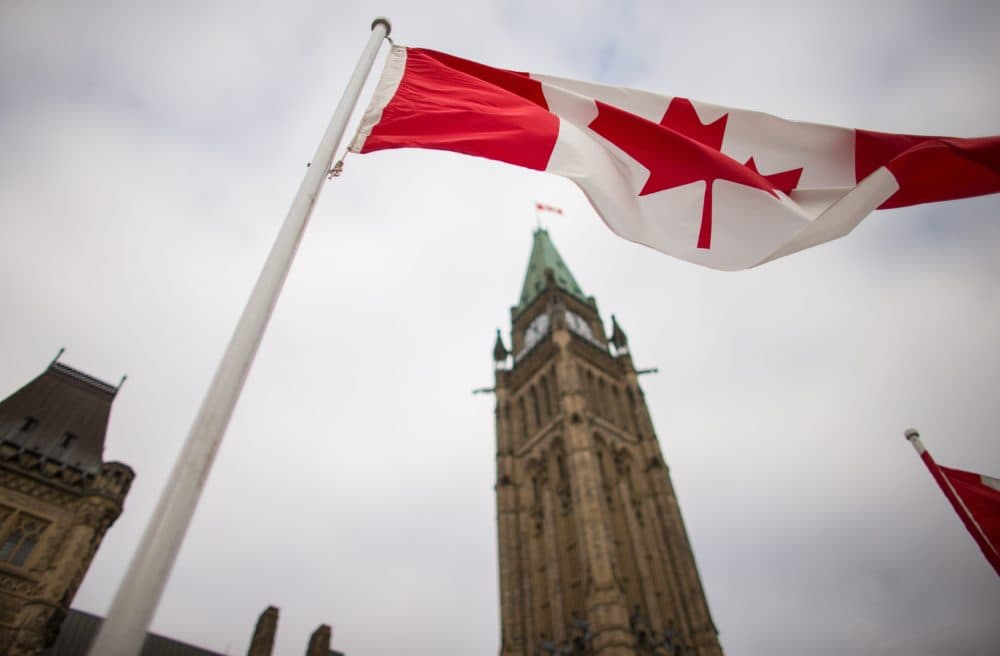 A Canadian flag flies in front of the peace tower on Parliament Hill in Ottawa, Canada. (Geoff Robins/AFP/Getty Images)