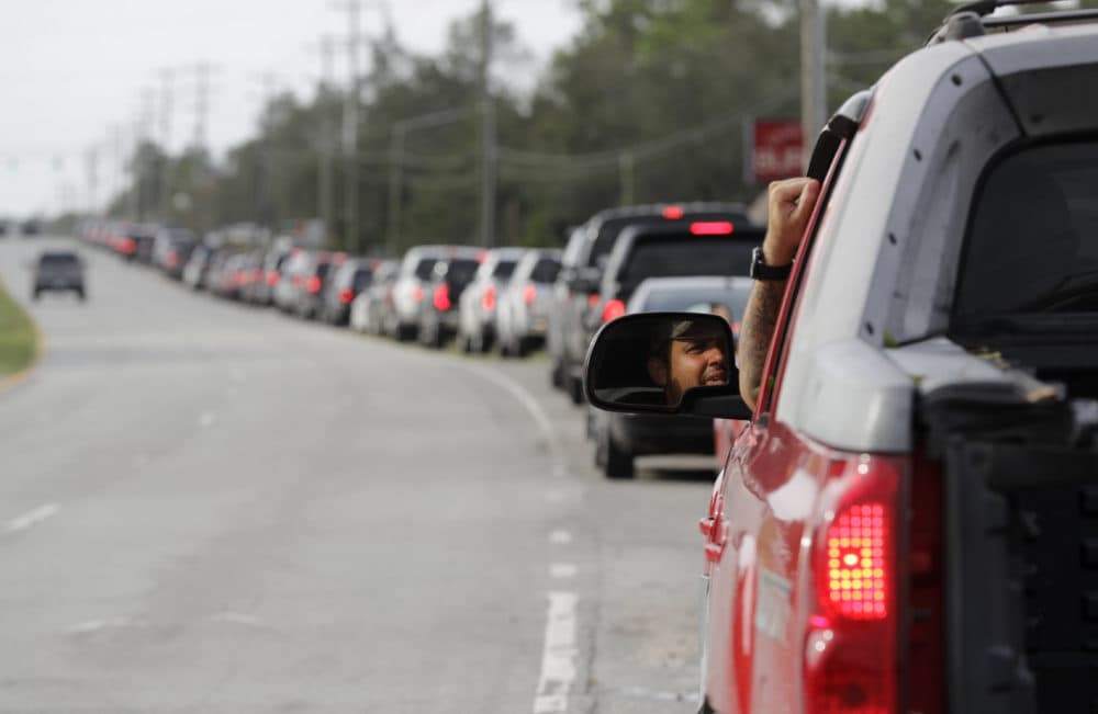 A man waits in a long line waiting for gas to arrive at a station near Wilmington, N.C., Monday, Sept. 17, 2018. Floodwaters from Hurricane Florence have cut off areas around Wilmington, N.C., forcing people to stand in long lines for fuel, food and other supplies. (Chuck Burton/AP)