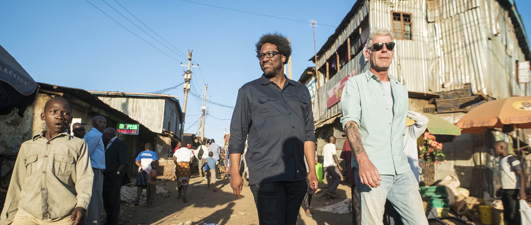 Anthony Bourdain (right) with W. Kamau Bell in the Kibera slums in Nairobi, Kenya, while filming the first episode of the final season of CNN's &quot;Parts Unknown.&quot; (Courtesy David Scott Holloway via CNN)