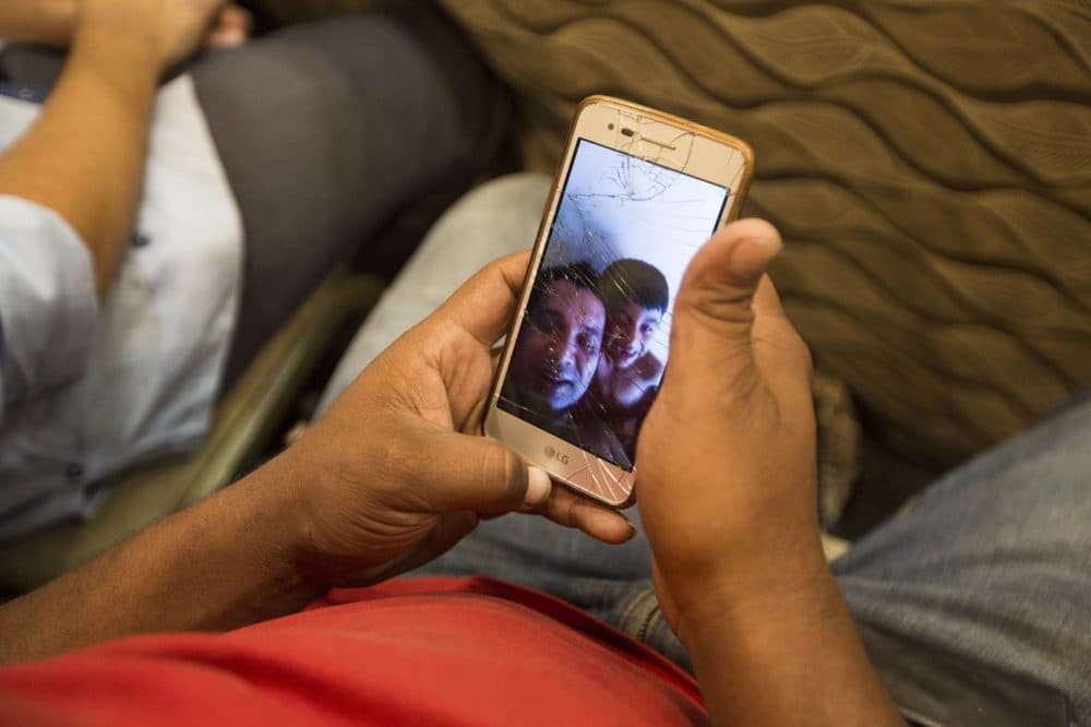 Carlos Alexis Hernandez Licona shows a selfie video of his 6-year-old son, Carlos Gabriel, and himself having fun while singing a song during a video made to send home. (Jesse Costa/WBUR)