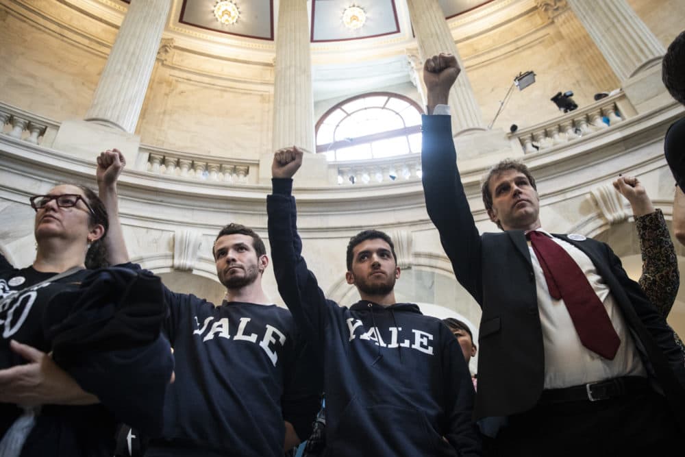 Protesters, including current Yale University law student Jesse Tripathi (second from right), rally against Supreme Court nominee Brett Kavanaugh in the rotunda of the Russell Senate Office Building on Capitol Hill, Sept. 24, 2018 in Washington, D.C. (Drew Angerer/Getty Images)